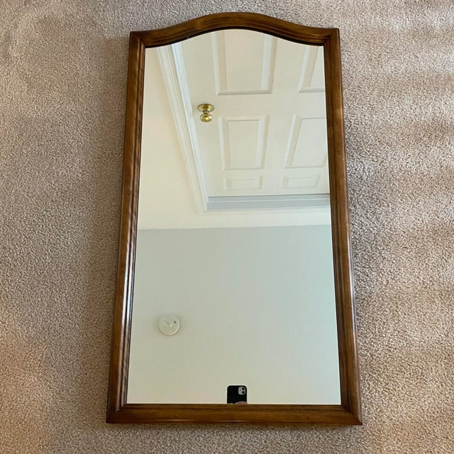 A classic vintage Ethan Allen Classic Manor mirror crafted in warm solid maple, with a beautifully shaped frame and...