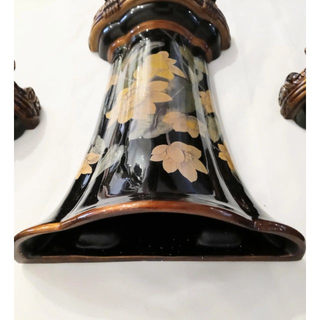 An incredible set of 3 extremely elegant black lacquer and antique gold floral wall sconce pockets. The sconces have a...