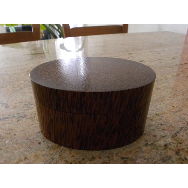 Both the body and lid of this jewelry -- or trinket -- box has been hollowed out of the same block of coconut palm wood so...