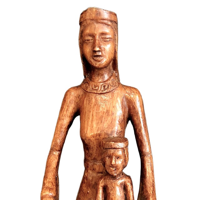On offer is a hand-carved wooden statue representing the Madonna and Child. The Virgin Mary holds the infant Jesus in the...