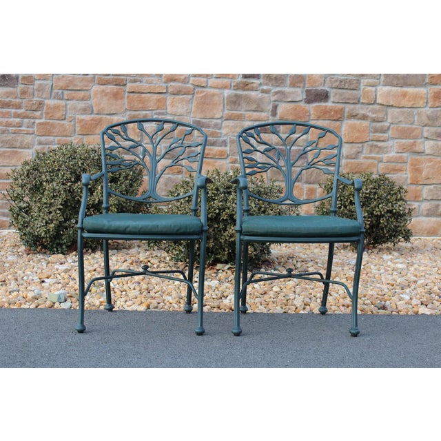 Crafted from aluminum, this pair of Woodard patio chairs is from the Heritage collection and is known as the tree of life...