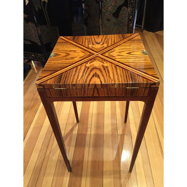 Elegant folding game table, inlaid precious wood, signed Gallé. Brass ball feet. This piece has an attribution mark, I am...