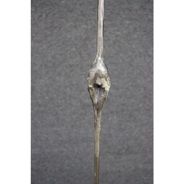 Set of three tall metal floor candle holders in a Brutalist style with a staggered height design. Each piece features a...