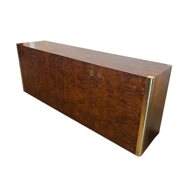 This beautiful 4-Door Credenza by Century Furniture is made of Burlwood and accented with Brass corner trims and hardwear....