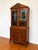 Elegant vintage china cabinet featuring beautiful wood grain, diamond-pane glass doors, and refined Federal-style...