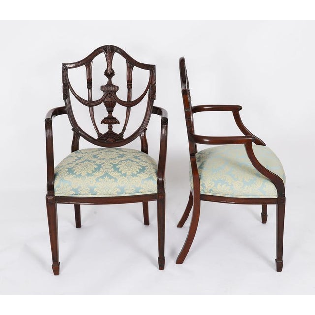 This is an absolutely fantastic antique pair of federal revival shield back arm chairs, circa 1920 in date. These chairs...