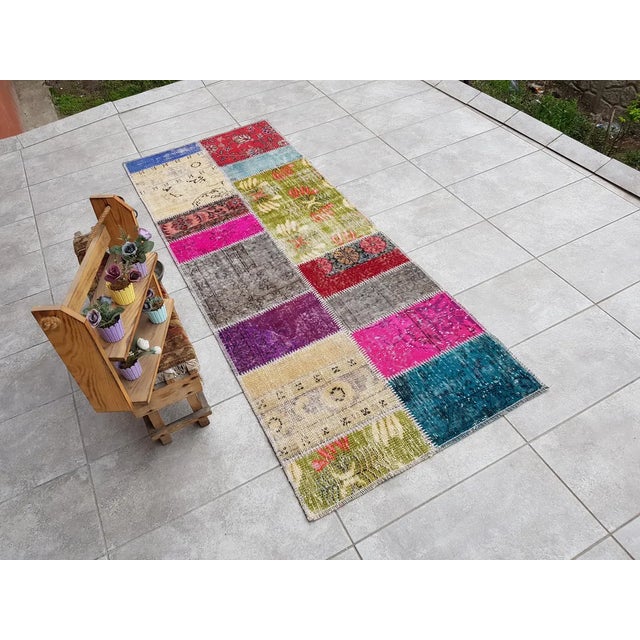 This is a vintage Turkish Oushak rug from the Mid 20th Century. The piece was hand-knotted.