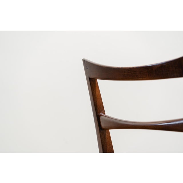 Set of four chairs designed in Denmark in the 1960s by Niels Kofoed. Made of walnut, they consist of a high backrest...