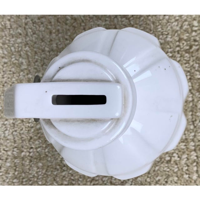 Vintage ceramic love grenade coin bank. Made of white ceramic with metal ring and peace symbol on the bottom.