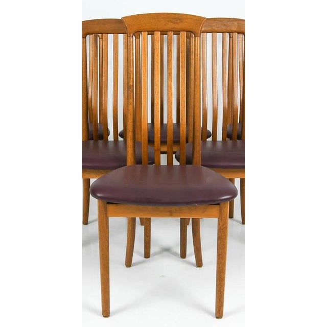 A set of 6 teak Danish modern dining chairs, circa 1960's/1970's. The chair seats are covered in a leatherette material...
