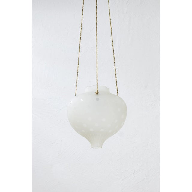 Swedish modern ceiling pendant attributed to Flygsfors. Made from etched and frosted glass with brass details, chain and...