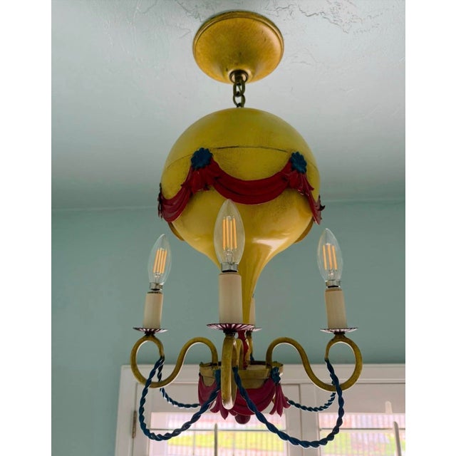 A whimsical mid century Italian chandelier in the shape of a hot air balloon. Designed by Maison Jansen in Paris in the...