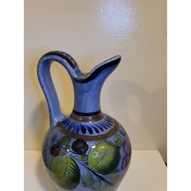 Thie is a beautiful Tolana folk art pitcher. It is handmade, handpainted and made in Mexico.