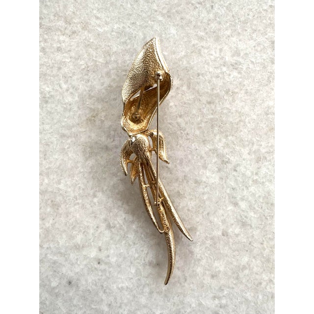 Gorgeous Goldtone Garnet and Cubic Zirconia Cali-lily stick pin by Sarah Coventry. Founded in 1949, the company did not...