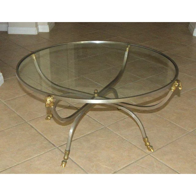 Italian steel and brass round cocktail or coffee table with ram's head and hoof detailing. Stamped on frame "Made In Italy".