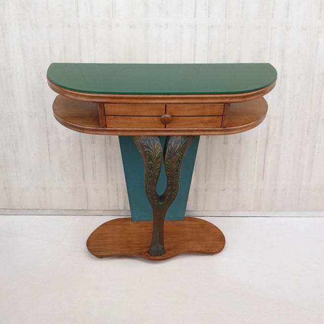 A beautiful console table whose lines are attributed to designer Osvaldo Borsani. Elegant and highly functional, it is...