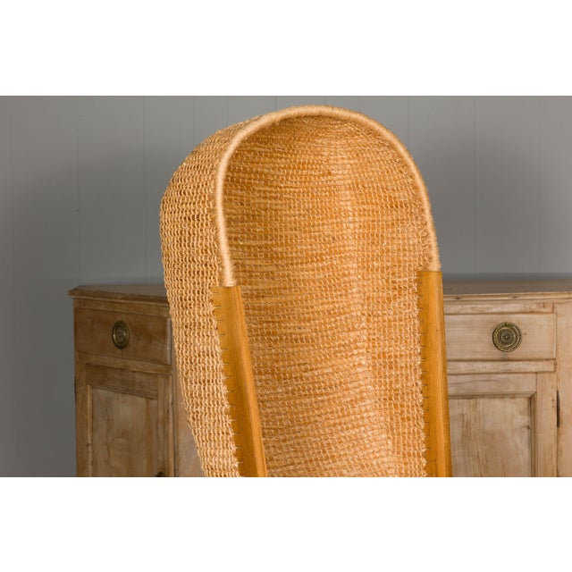 A Scottish Orkney Island canopy chair from the mid 20th century with handwoven straw hooded back, rush seat, open...