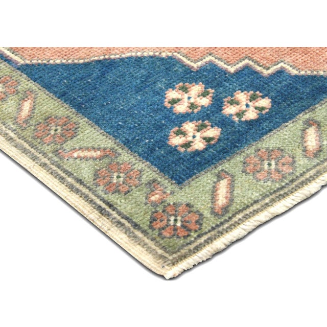 Vintage wool yastic from Turkey's Oushak region, sized 1'8" x 3'2". Hand-woven with traditional techniques, this piece...