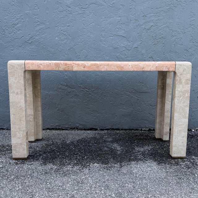 This postmodern console table pairs polished tessellated stone with a refined architectural silhouette. Ivory tiles with...