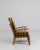 A distinctive Brutalist armchair emphasizing solid construction and bold, angular lines. The oak frame showcases...