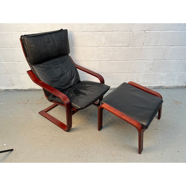 Vintage black leather Poäng chair and matching ottoman designed by Noboru Nakamura for IKEA, one of the most recognizable...
