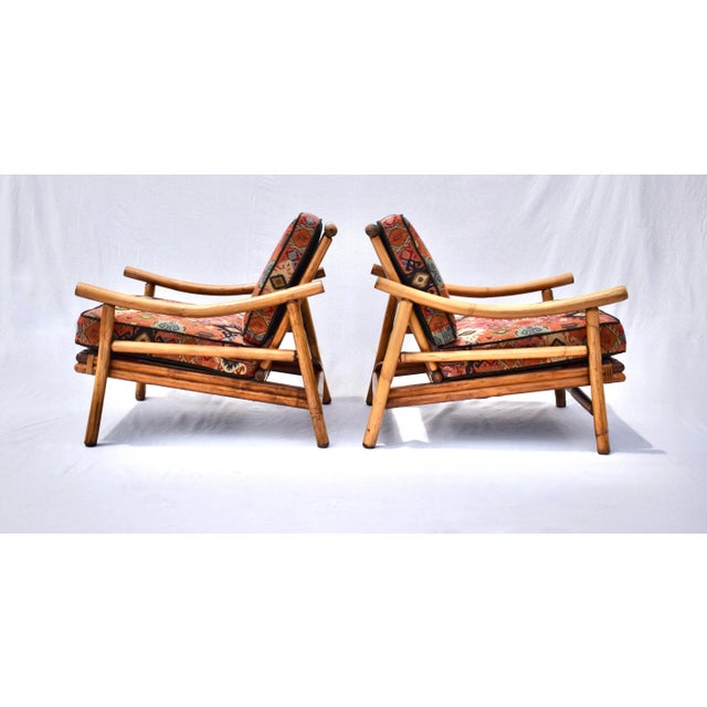 A pair of Ficks Reed Pagoda style bamboo rattan lounge chairs with hardwood seats and original spring construction. New...