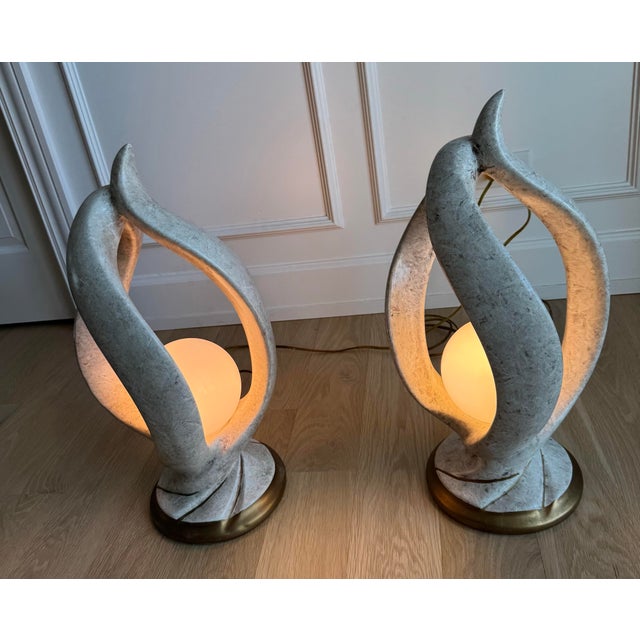 A monumental pair of Postmodern sculptural table lamps from the 1980s, featuring a dramatic "flame" or "ribbon"...