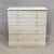 A classic antique circa 1920s English pine dresser with old cream colored paint accented with a white French line. The...