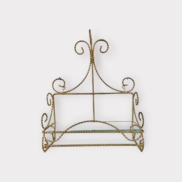 Chic and sculptural, this vintage Italian wall shelf embodies the elegance of Hollywood Regency design with its twisted...