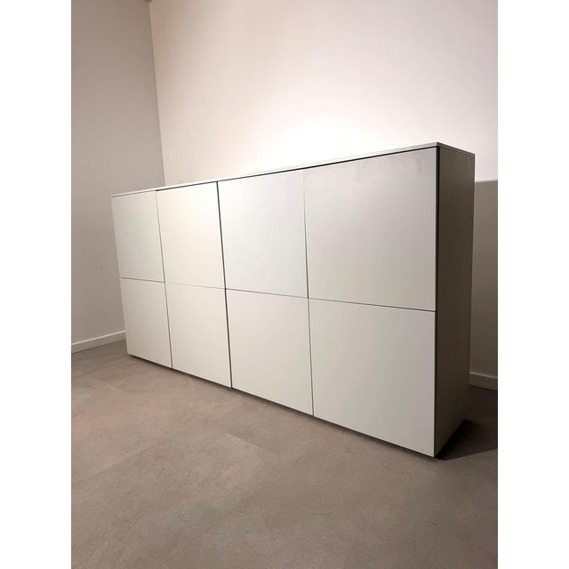 Elegant and timeless Lema sideboard finished in a sleek matte white lacquer. Its minimalist Italian design, clean lines...