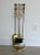 Late 20th Century Set of Neo-Classical Brass Finish Fireplace Toos in a Stand. The set includes an ash shovel, tongs, a...