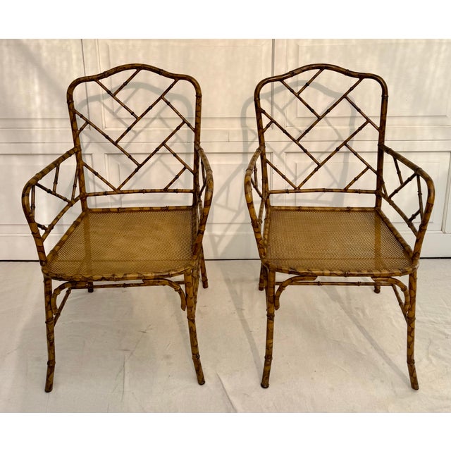 This striking pair of faux bamboo metal armchairs dates to the mid-20th century, circa 1960s. Crafted in steel and...