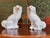 A pair of Victorian English Staffordshire pottery spaniels, sitting upright and facing each other, glazed in white with...