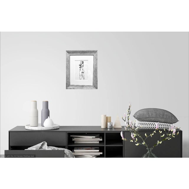 Unique and contemporary ink drawing of a beautiful and sensuous model in an atelier in Paris, France. This drawing will be...