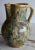 19th Century French Jaspe multicolored glazed pitcher in terracotta with greens, browns, blues and yellow. The pitcher has...