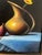 This professionally framed piece pops with its black background and rich colors of yellows, gold, blue and burnt reds....