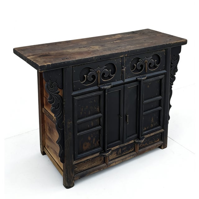 Crafted in 1826 from solid elm wood, this antique sideboard is distinguished by its deep, hand-carved scrolling motifs on...