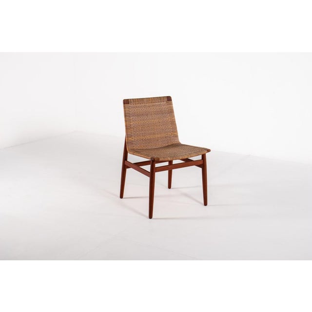 The very rare Jørgen Høj Teak and Rattan Chair for Thorald Madsen is a prime example of 1950s Danish modern design....
