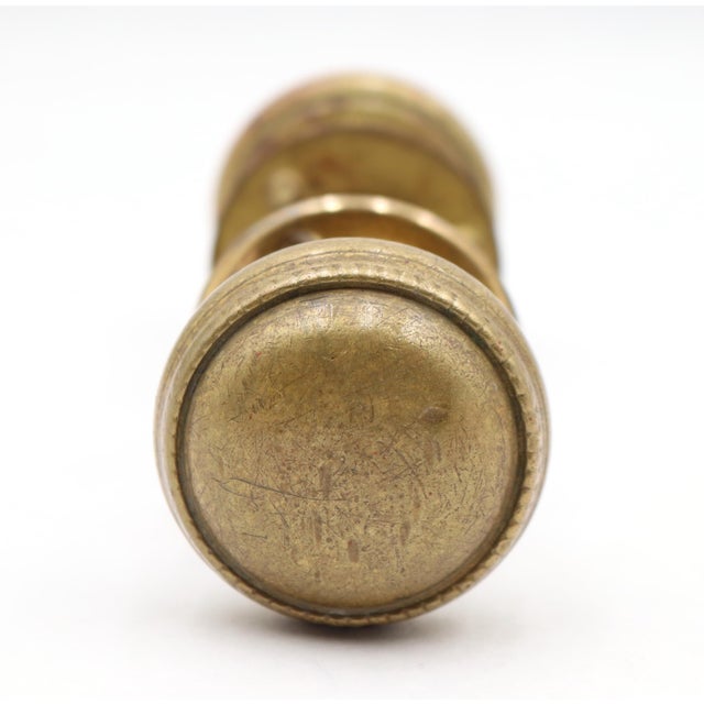 Traditional style brass passage door knob set with a beaded design. Priced as two door knobs, one rosette, and a spindle....