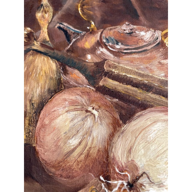 A vintage framed oil on canvas board depicting a kitchen still life scene with onions, kettle, and other kitchen tools....