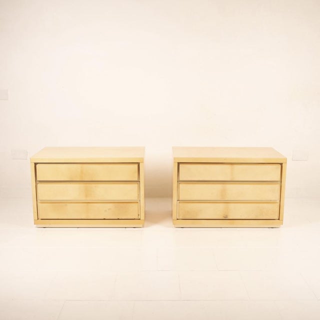 Discover the refinement of Italian design with this extraordinary pair of parchment bedside tables, the result of Aldo...