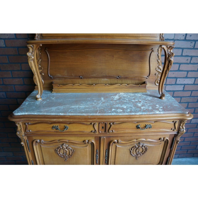 Absolutely Stunning! This unique French antique marble top buffet is tres magnifique. The architectural embellishments and...