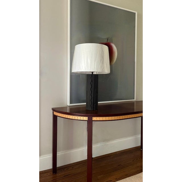 A pair of highly textured metal lamps with matching rusticated finials. Lamp bases feature a scallop leading edge and...