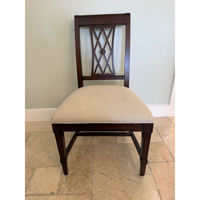 A latticework back and square-tapered leg chairs in cello finish. Crafted from solid agathis Seat height: 19” Squared,...