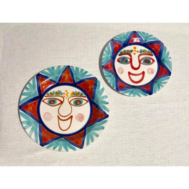 Striking and artistically expressive, these MCM DeSimone Italian ceramic sun plates feature vibrant hand-painted designs...
