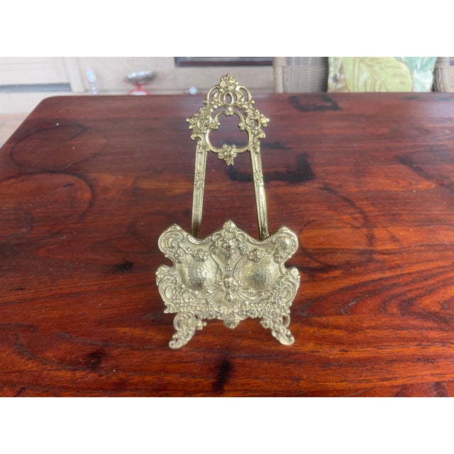 Art Nouveau brass easel with beautiful inspired scrollwork and decorative detailing throughout. At approximately 8.5"...