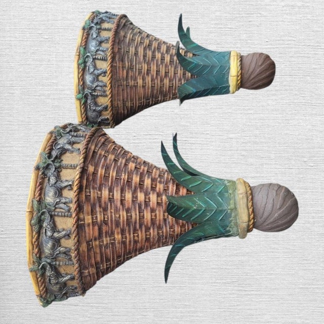 A wonderful pair of vintage tropical wall brackets sconces. The sconces feature a whimsical design with carved elephants...