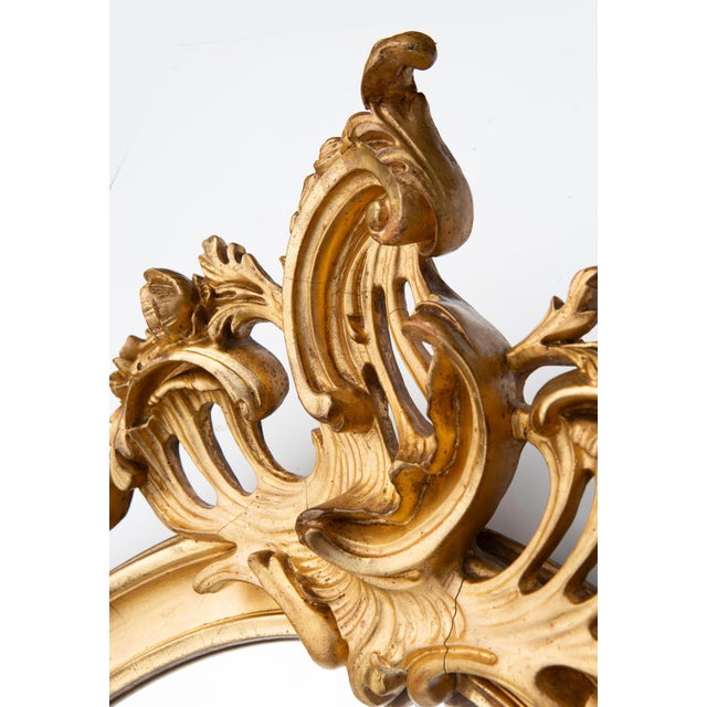 Gold gilding on most of the frame. Original beveled glass and wooden back.