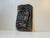 A stylized hunting motif conveyed in to this pronounced wall plaque. It is cast in spelter, a zinc alloy and bronze/copper...