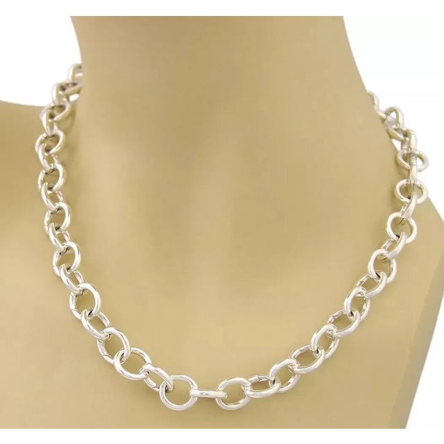 Elegant authentic clasping necklace from Tiffany & Co. It is crafted from solid sterling silver with high polished round...
